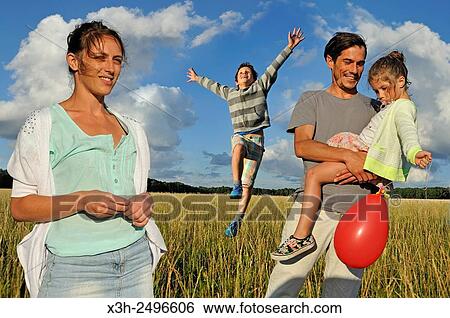 young parents playing with their children in a field, Ile-de-France, France, Europe. View Large Photo Image Stock Photograph - young parents playing with their children in a field, Ile-de-France, France, Europe.. Fotosearch
