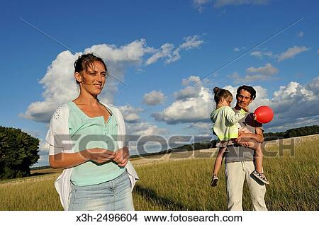 young parents with their little daughter, Ile-de-France, France, Europe. View Large Photo Image Picture - young parents with their little daughter, Ile-de-France, France, Europe.. Fotosearch