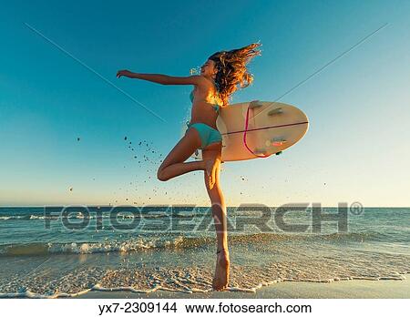 Young teenager with her surf board at the beach. Tarifa, Cadiz, Costa de la Luz, Andalusia, Spain. View Large Photo Image Picture - Young teenager with her surf board at the beach. Tarifa, Cadiz, Costa de la Luz, Andalusia, Spain.. Fotosearch
