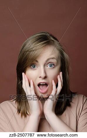 Young woman hands on face in shock. View Large Photo Image Stock Photo - Young woman hands on face in shock.. Fotosearch