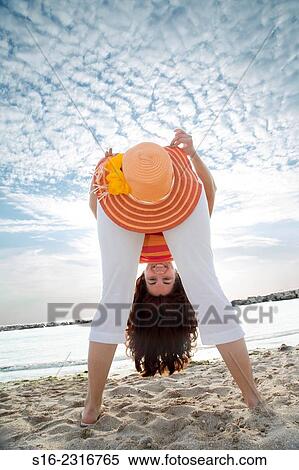 Young woman having fun with a straw hat on the beach View Large Photo Image Stock Photography - Young woman having fun with a straw hat on the beach. Fotosearch