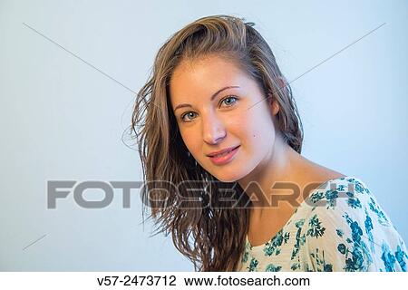 Young woman smiling and looking at the camera. View Large Photo Image Stock Image - Young woman smiling and looking at the camera.. Fotosearch