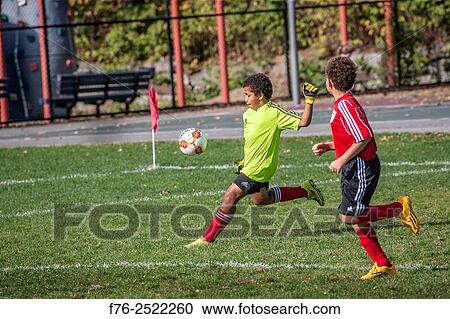 10 year old, bi-racial caucasian/african american boy (goalie position) playing soccer / kicking a soccer ball.. View Large Photo Image Stock Image - 10 year old, bi-racial caucasian/african american boy (goalie position) playing soccer / kicking a soccer ball... Fotosearch