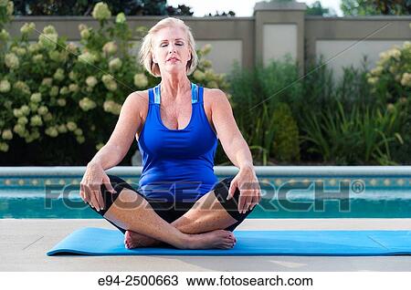56 year old blond woman in fitness clothing by a backyard swimming pool. View Large Photo Image Stock Image - 56 year old blond woman in fitness clothing by a backyard swimming pool.. Fotosearch