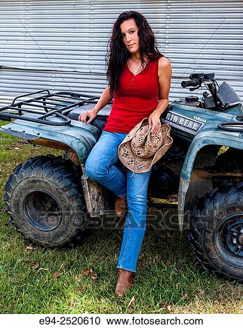 A 38 year old brunette woman sitting on an ATV on a farm. View Large Photo Image Stock Image - A 38 year old brunette woman sitting on an ATV on a farm.. Fotosearch
