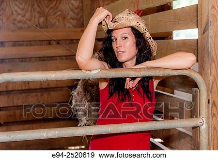 A 38 year old brunette woman wearing a straw hat in a barn setting. View Large Photo Image Stock Photo - A 38 year old brunette woman wearing a straw hat in a barn setting.. Fotosearch