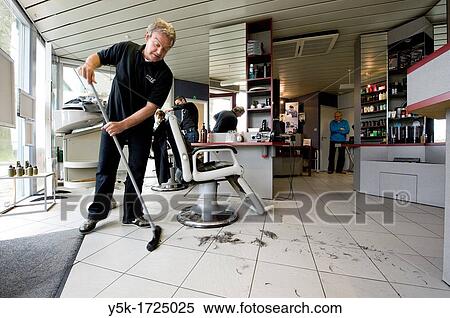 A barber cleaning the floor of his hairdresser salon after a haircut of one of his customers. View Large Photo Image Stock Photography - A barber cleaning the floor of his hairdresser salon after a haircut of one of his customers.. Fotosearch