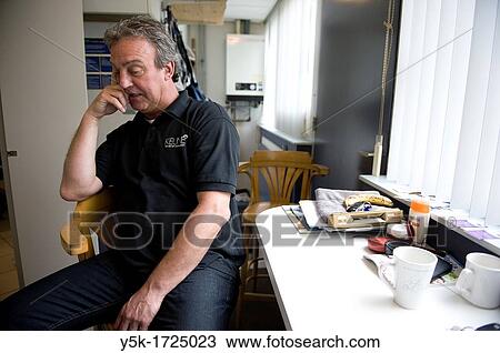 A barber having a break in the back of his hairdresser salon. View Large Photo Image Stock Image - A barber having a break in the back of his hairdresser salon.. Fotosearch