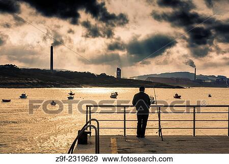 A man contemplates an aluminium plant from the port of San Ciprian, Lugo, Galicia, Spain View Large Photo Image Stock Photo - A man contemplates an aluminium plant from the port of San Ciprian, Lugo, Galicia, Spain. Fotosearch