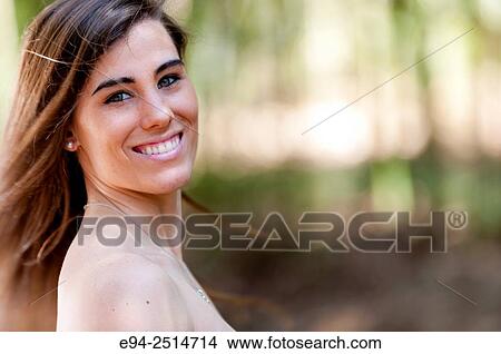 A smiling 22 year old woman with long hair smiling at the camera. View Large Photo Image Picture - A smiling 22 year old woman with long hair smiling at the camera.. Fotosearch