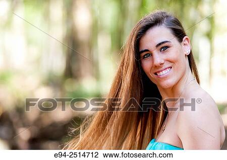 A smiling 22 year old woman with long hair smiling at the camera. View Large Photo Image Stock Image - A smiling 22 year old woman with long hair smiling at the camera.. Fotosearch