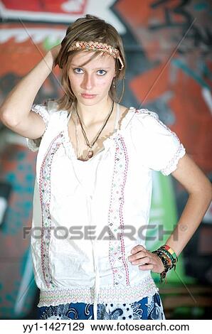 A young woman posing in front of a graffity. View Large Photo Image Stock Photo - A young woman posing in front of a graffity.. Fotosearch