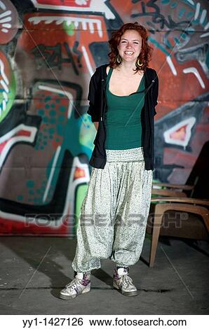 A young woman posing in front of a graffity. View Large Photo Image Stock Photograph - A young woman posing in front of a graffity.. Fotosearch