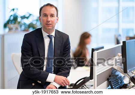 Stock Image - Almere, Netherlands. 23rd floor of an office-building. Portrait of a man in suit, working as a marketing manager for a cooperation.. Fotosearch