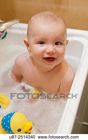 Stock Image - Baby Boy and Yellow Duck.... Fotosearch