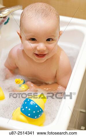 Stock Image - Baby Boy and Yellow Duck.... Fotosearch