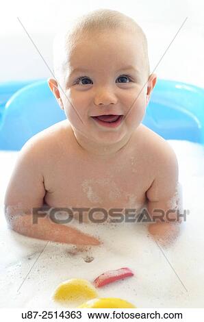 Stock Image - Baby Boy and Yellow Duck. Fotosearch