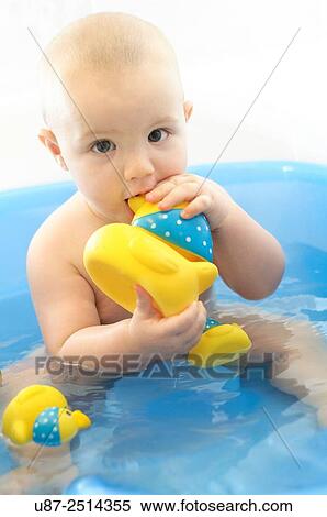 Stock Photography - Baby Boy and Yellow Duck. Fotosearch