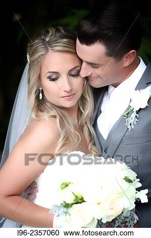 Bride and groom enjoying a private, intimate moment after their wedding View Large Photo Image Stock Image - Bride and groom enjoying a private, intimate moment after their wedding. Fotosearch