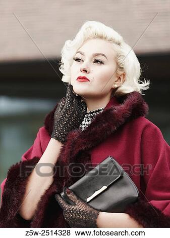 Close up, fashionable blond posing and she wearing red coat, urban scene. View Large Photo Image Stock Photo - Close up, fashionable blond posing and she wearing red coat, urban scene.. Fotosearch