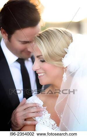 Close up on happy couple embracing, enjoying a private moment after their wedding View Large Photo Image Stock Image - Close up on happy couple embracing, enjoying a private moment after their wedding. Fotosearch