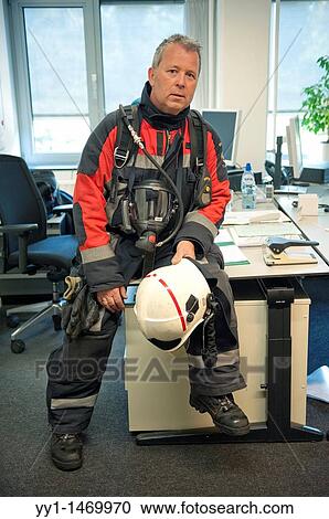 Firefighter in fireproof turnout gear on his regular job in the barracks. View Large Photo Image Stock Image - Firefighter in fireproof turnout gear on his regular job in the barracks.. Fotosearch