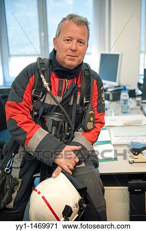 Firefighter in fireproof turnout gear on his regular job in the barracks. View Large Photo Image Stock Image - Firefighter in fireproof turnout gear on his regular job in the barracks.. Fotosearch
