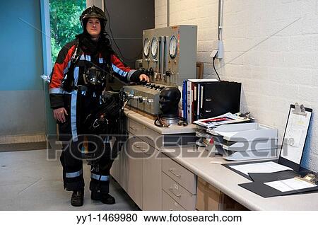 Firefighter in fireproof turnout gear on his regular job in the barracks. View Large Photo Image Stock Image - Firefighter in fireproof turnout gear on his regular job in the barracks.. Fotosearch