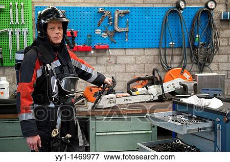 Firefighter in fireproof turnout gear on his regular job in the barracks. View Large Photo Image Stock Photo - Firefighter in fireproof turnout gear on his regular job in the barracks.. Fotosearch