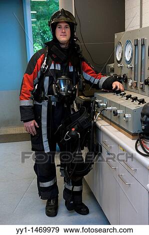 Firefighter in fireproof turnout gear on his regular job in the barracks. View Large Photo Image Stock Photo - Firefighter in fireproof turnout gear on his regular job in the barracks.. Fotosearch