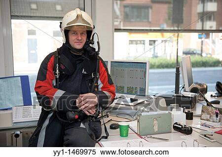 Stock Photography - Firefighter in fireproof turnout gear on his regular job in the barracks.. Fotosearch