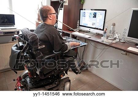 Handicapped man working from home on his computer. View Large Photo Image Stock Photograph - Handicapped man working from home on his computer.. Fotosearch
