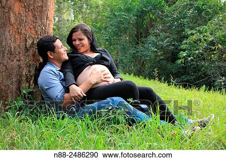 Stock Image - Hispanic couple expecting first child. Fotosearch