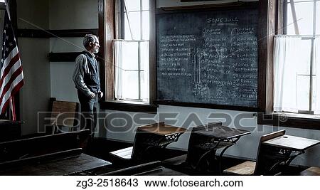 Man dressed as a school teacher inside an Abandoned Scholl house at sunset in Kansas. View Large Photo Image Stock Image - Man dressed as a school teacher inside an Abandoned Scholl house at sunset in Kansas.. Fotosearch