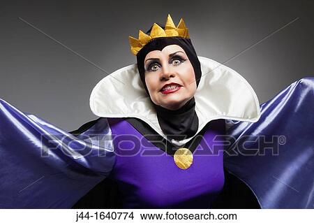Picture - Mature woman wearing the evil queen costume. Fotosearch