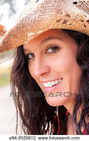 Portrait of a 38 year old brunette woman wearing a straw hat outdoors. View Large Photo Image Stock Image - Portrait of a 38 year old brunette woman wearing a straw hat outdoors.. Fotosearch