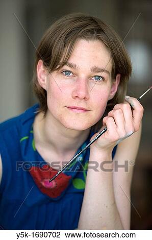 Portrait of a female painter during creation of a collage. View Large Photo Image Stock Image - Portrait of a female painter during creation of a collage.. Fotosearch