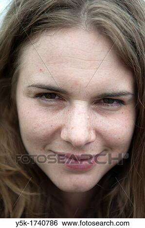 Stock Photograph - Portrait of a young, attractive brunette with strait, long hair.. Fotosearch