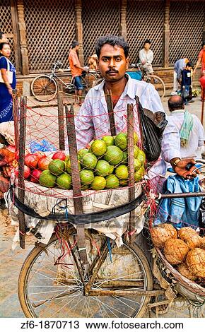 Stock Image - Portrait of vendor of vegetables in Durbar Square in center of village of Kathmandu Nepal. Fotosearch