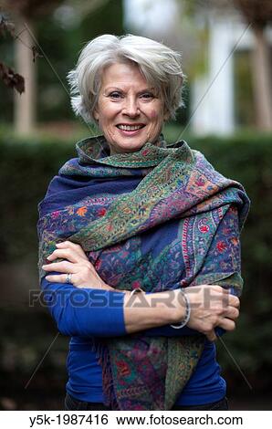 Rotterdam, Hillergersberg, Netherlands. Portrait of an elder woman, standing in front of a hedge in her garden, wearing a shawl against the cold. View Large Photo Image Stock Photograph - Rotterdam, Hillergersberg, Netherlands. Portrait of an elder woman, standing in front of a hedge in her garden, wearing a shawl against the cold.. Fotosearch