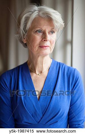 Rotterdam, Hillergersberg, Netherlands. Portrait of an elder woman, sitting near the livingroom window and in frront of a curtain. View Large Photo Image Stock Photography - Rotterdam, Hillergersberg, Netherlands. Portrait of an elder woman, sitting near the livingroom window and in frront of a curtain.. Fotosearch