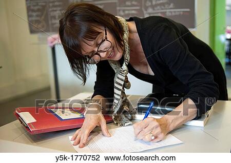 Rotterdam, Netherlands. A female language teacher volunteers to educate undocumented aliens in The Netherlands into the Dutch Language. Once and a while test results are documented. View Large Photo Image Stock Image - Rotterdam, Netherlands. A female language teacher volunteers to educate undocumented aliens in The Netherlands into the Dutch Language. Once and a while test results are documented.. Fotosearch