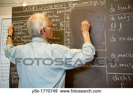 Rotterdam, Netherlands. A retired language teacher volunteers to educate undocumented aliens in The Netherlands into the Dutch Language. View Large Photo Image Stock Photo - Rotterdam, Netherlands. A retired language teacher volunteers to educate undocumented aliens in The Netherlands into the Dutch Language.. Fotosearch