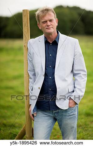 Rotterdam, Netherlands An accountant, working for small companies, in the field behind his office. View Large Photo Image Stock Photograph - Rotterdam, Netherlands An accountant, working for small companies, in the field behind his office.. Fotosearch