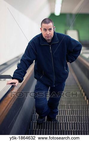 Rotterdam, Netherlands. Male mechanic / maintenance worker on vintage escalator. View Large Photo Image Stock Image - Rotterdam, Netherlands. Male mechanic / maintenance worker on vintage escalator.. Fotosearch