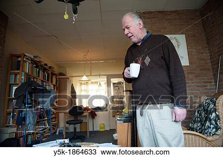 Rotterdam, Netherlands. Older man in his disorganized living-room. View Large Photo Image Stock Image - Rotterdam, Netherlands. Older man in his disorganized living-room.. Fotosearch