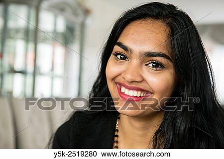 Rotterdam, Netherlands. Portrait of a young, attractive Hinsoestan woman, while having a conversation in het living room. View Large Photo Image Stock Image - Rotterdam, Netherlands. Portrait of a young, attractive Hinsoestan woman, while having a conversation in het living room.. Fotosearch