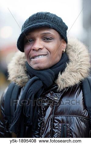 Rotterdam, Netherlands. African-American man in the streets, smiling and biting his lips. View Large Photo Image Stock Photo - Rotterdam, Netherlands. African-American man in the streets, smiling and biting his lips.. Fotosearch