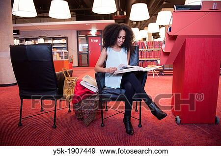 Rotterdam, Netherlands. Young, African woman reading educational literature about photography in a public Library. View Large Photo Image Stock Photo - Rotterdam, Netherlands. Young, African woman reading educational literature about photography in a public Library.. Fotosearch