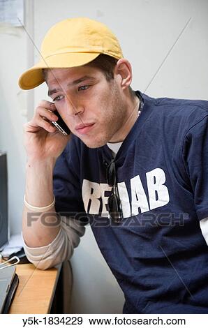 Rotterdam, Netherlands. Young, English employee of a gallery making a phone-call in the office. View Large Photo Image Stock Photo - Rotterdam, Netherlands. Young, English employee of a gallery making a phone-call in the office.. Fotosearch